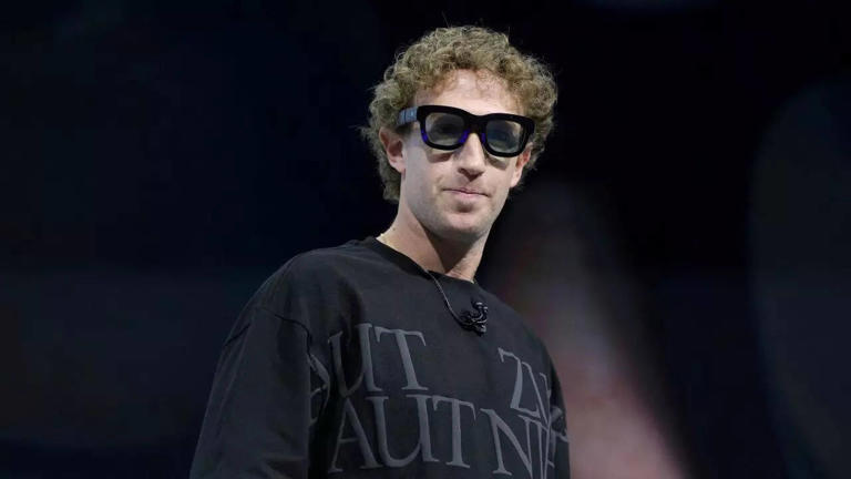A photo of an idiot (Mark Zuckerberg) wearing the companies smart glasses
