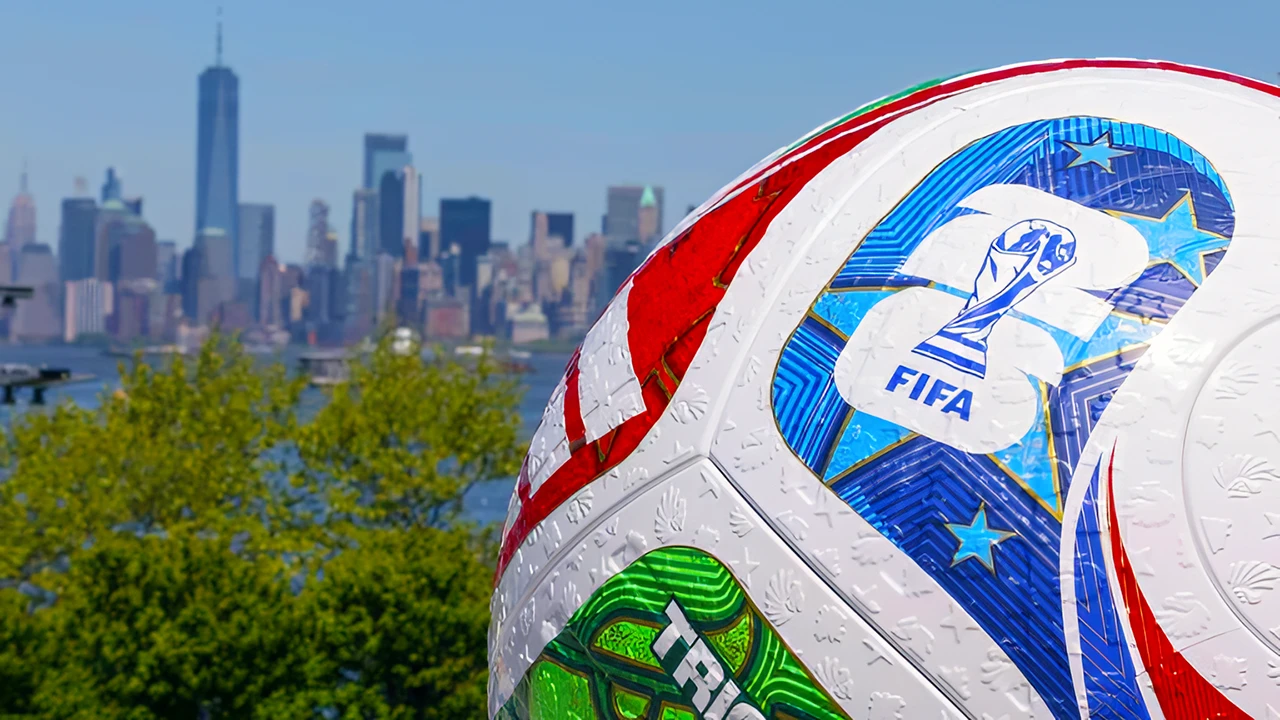 Soccer Football with FIFA logos pictured in front of a skyline of skyscrapers in the distance